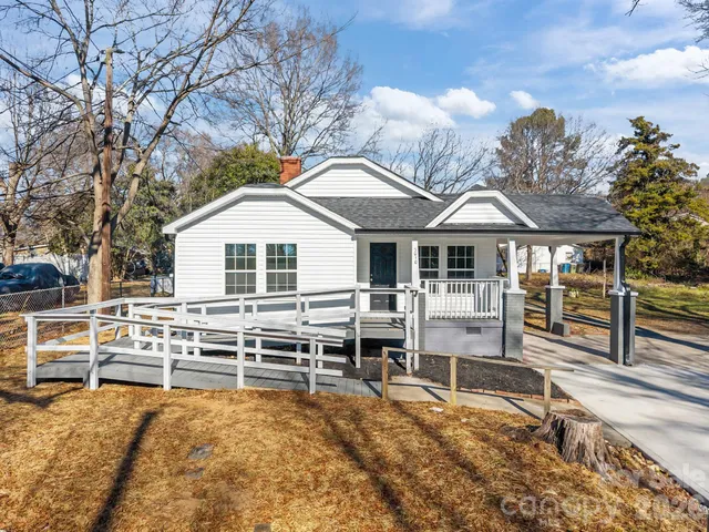a front view of a house with wooden fence