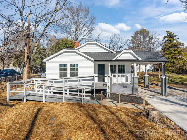 a front view of a house with wooden fence