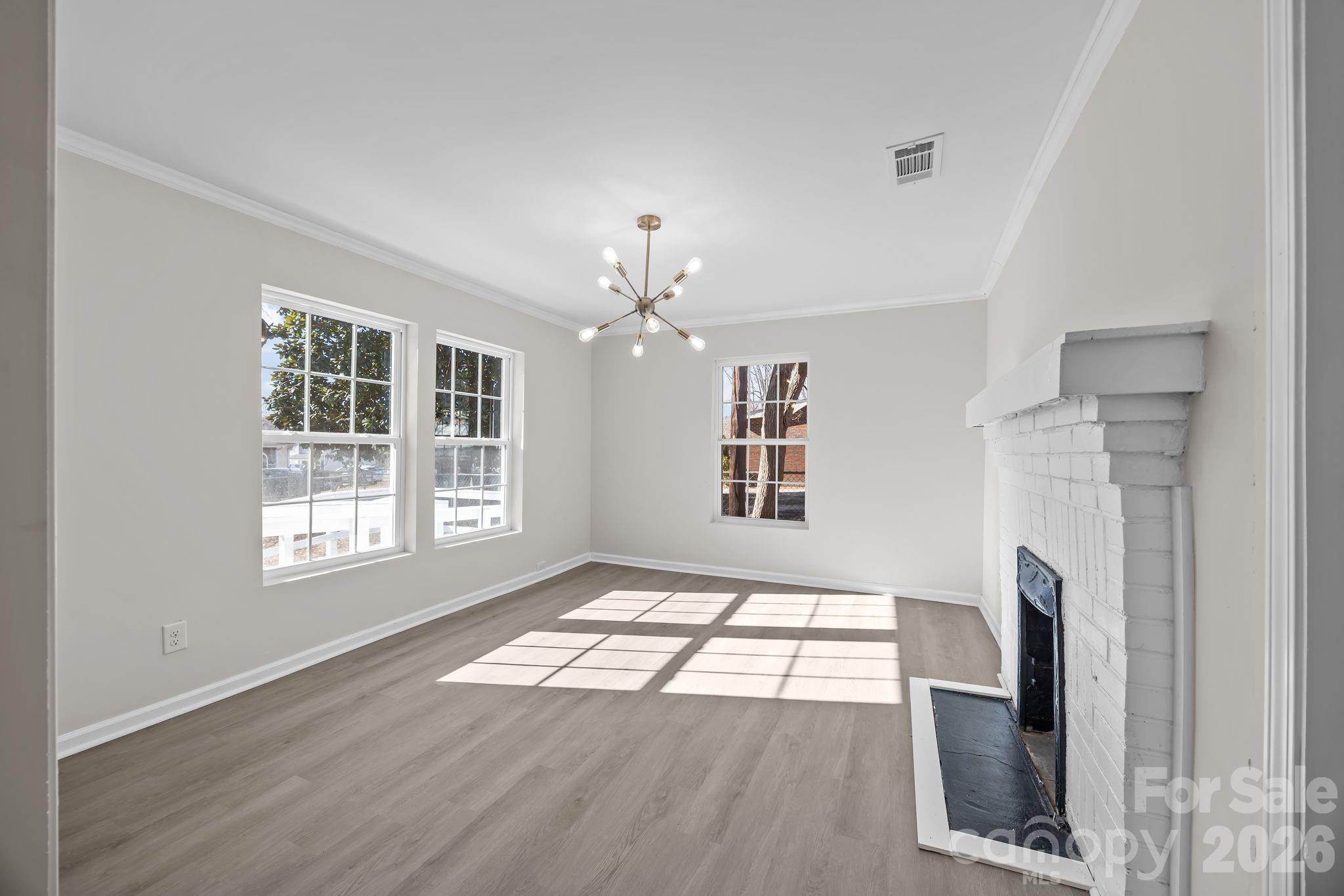 5010 Athens Street Kannapolis, NC 28081 - Photo 16 of 36 a view of an empty room with wooden floor and a window