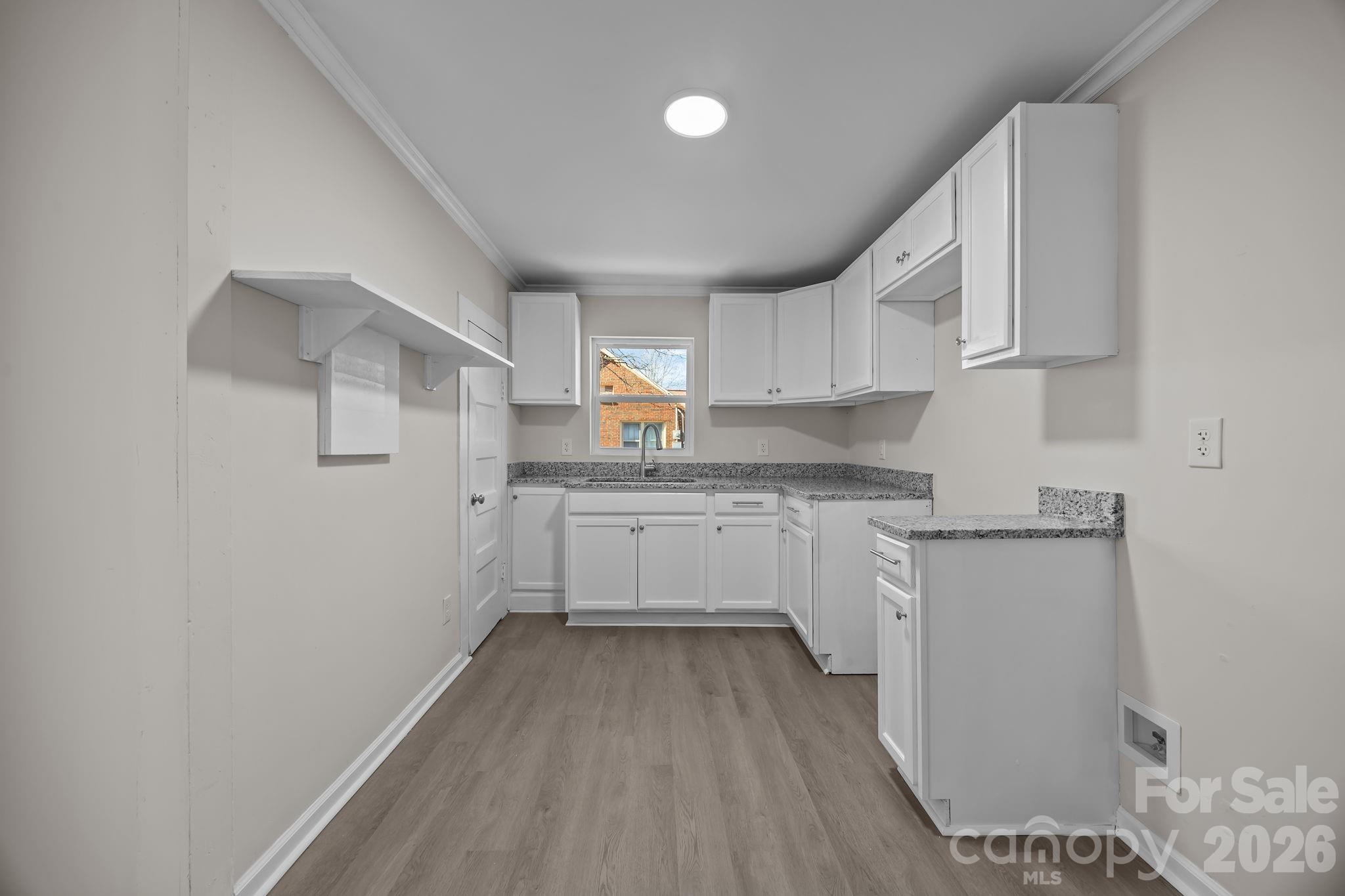 5010 Athens Street Kannapolis, NC 28081 - Photo 18 of 36 a kitchen with cabinets and wooden floor