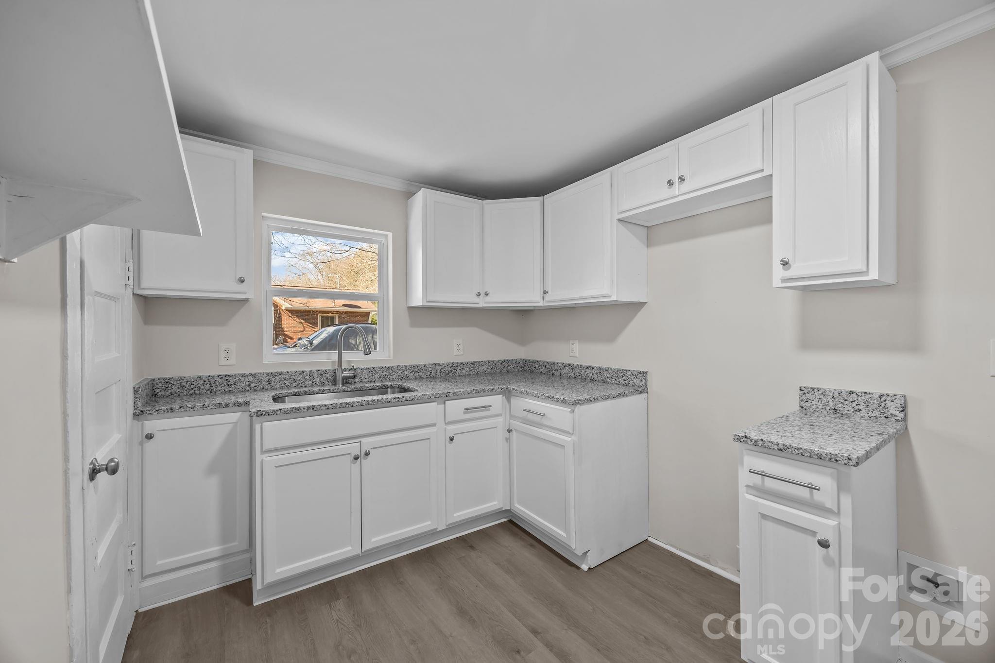 5010 Athens Street Kannapolis, NC 28081 - Photo 20 of 36 a kitchen with granite countertop a sink and cabinets