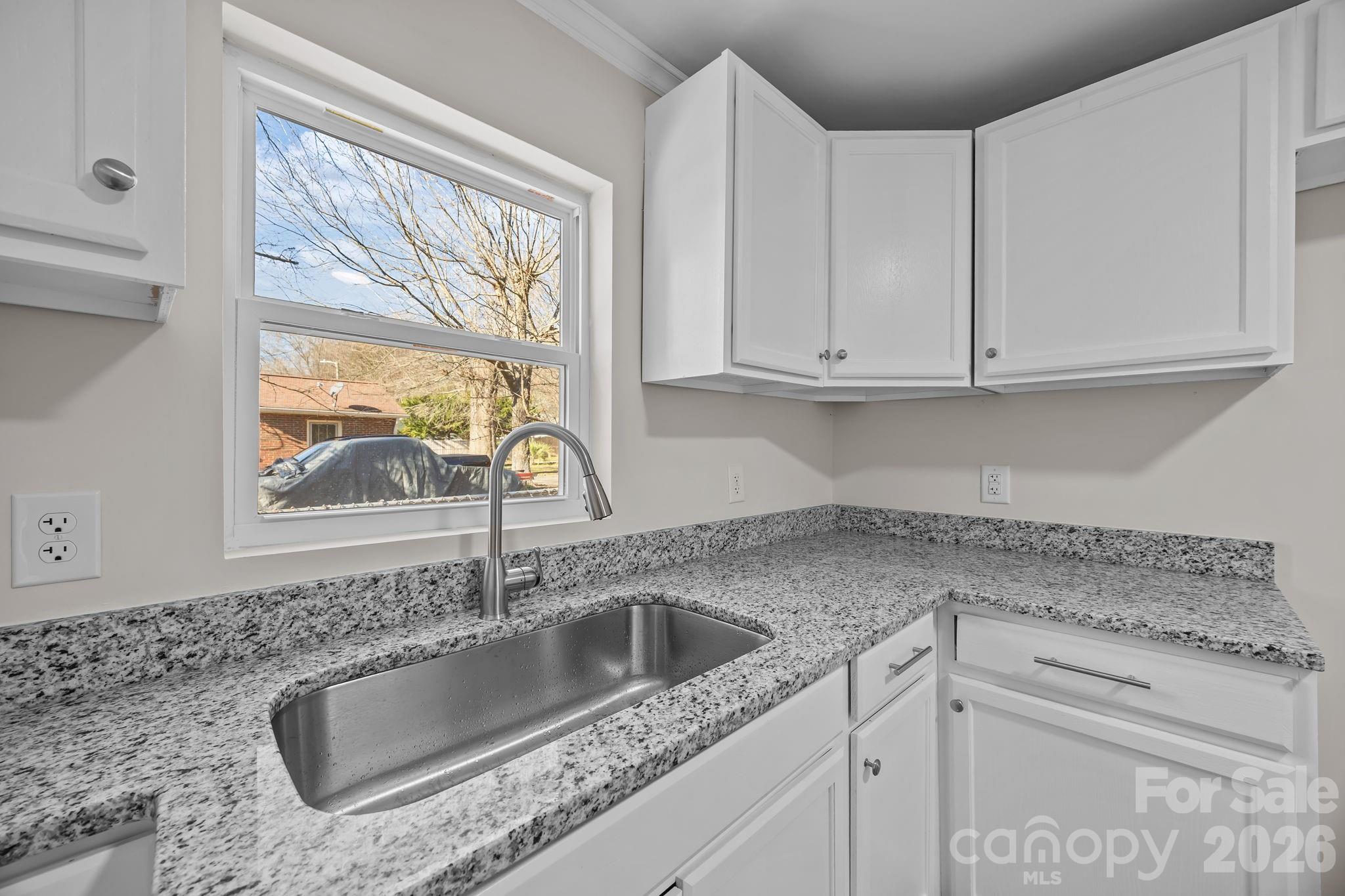5010 Athens Street Kannapolis, NC 28081 - Photo 21 of 36 a kitchen with granite countertop a sink and cabinets