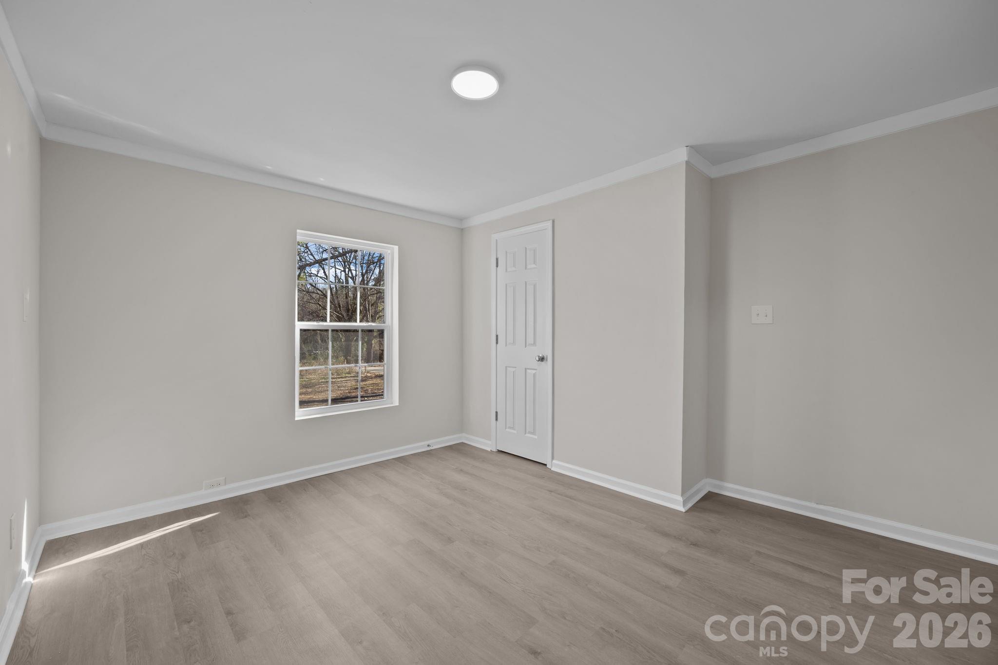5010 Athens Street Kannapolis, NC 28081 - Photo 25 of 36 a view of an empty room with wooden floor and a window