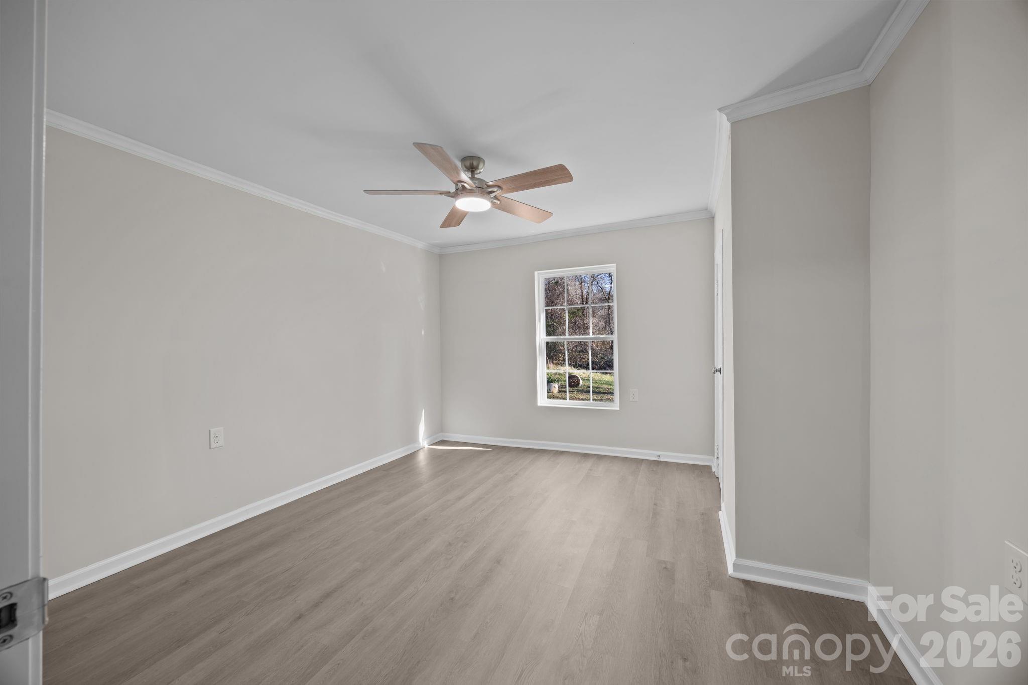 5010 Athens Street Kannapolis, NC 28081 - Photo 29 of 36 wooden floor in an empty room with a window