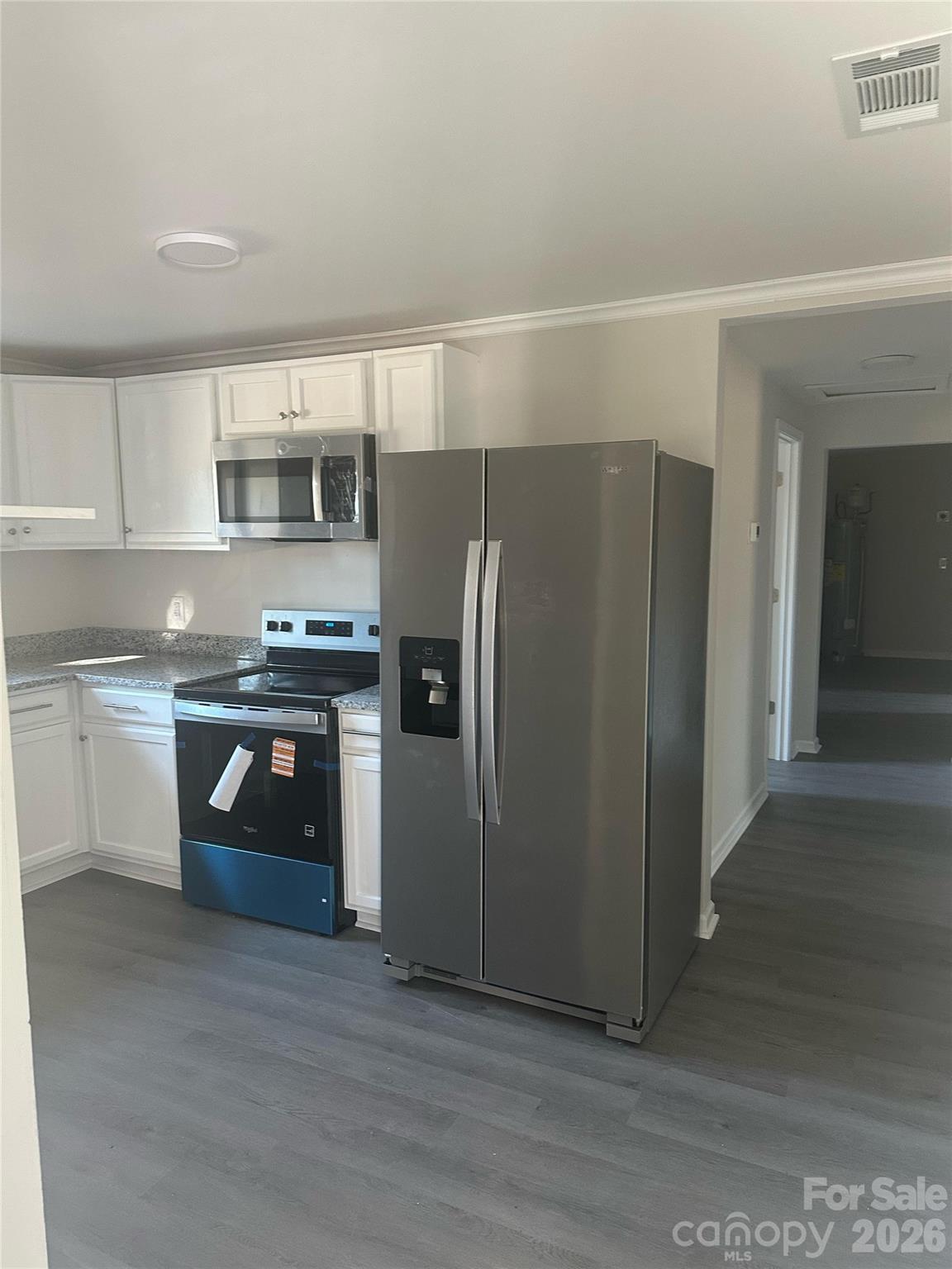 5010 Athens Street Kannapolis, NC 28081 - Photo 36 of 36 a kitchen with a refrigerator sink and cabinets