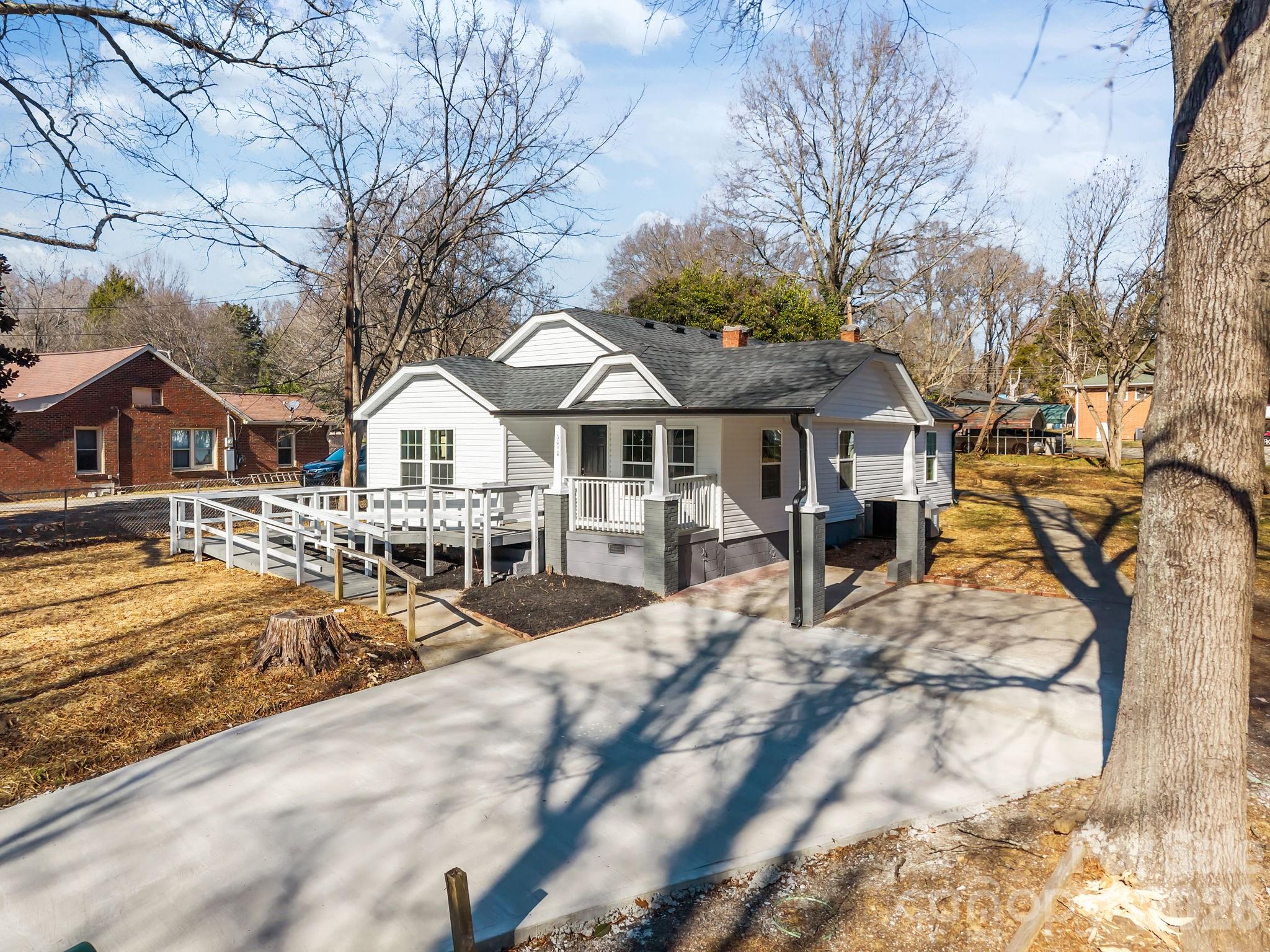 5010 Athens Street Kannapolis, NC 28081 - Photo 4 of 36 a view of a white house with a yard patio and slide