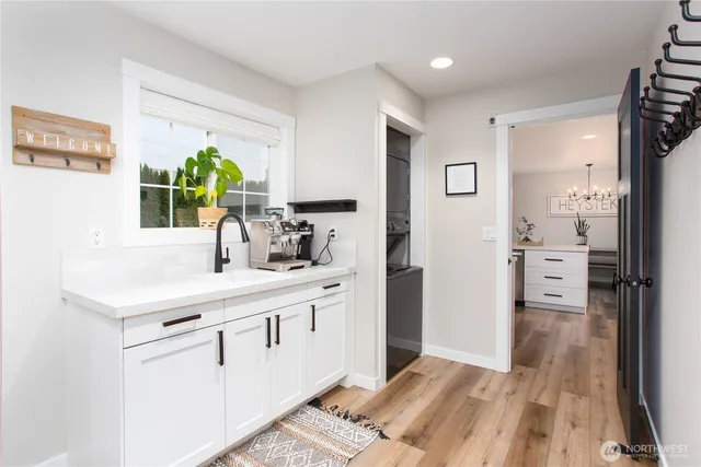 a kitchen with a refrigerator a sink and a window