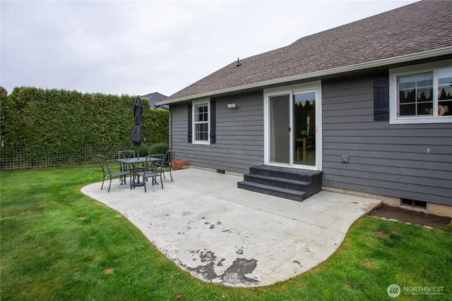a view of a house with backyard porch and sitting area
