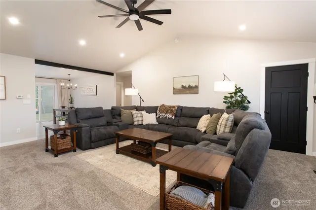 a living room with furniture and a ceiling fan