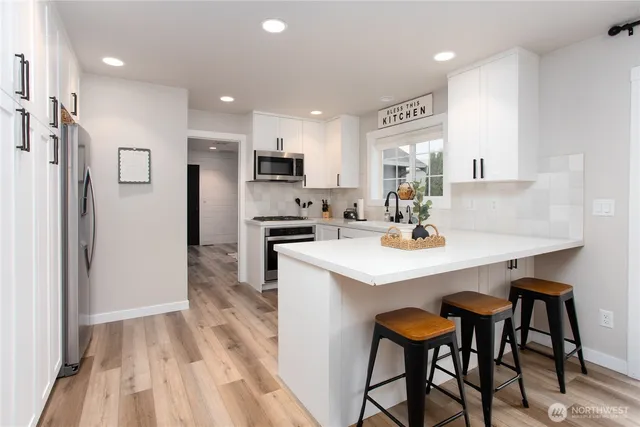 a kitchen with kitchen island a sink table and chairs