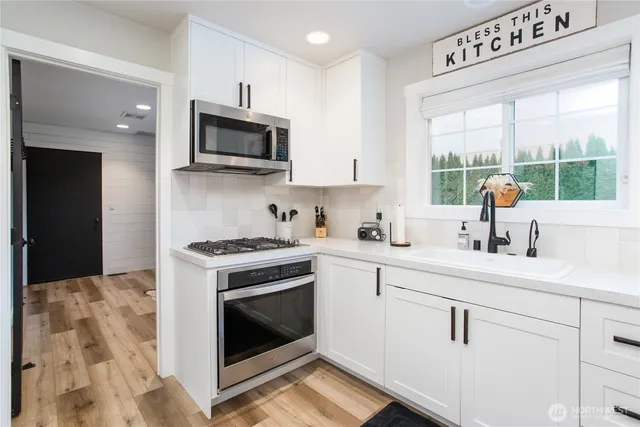 a kitchen with a sink stove and microwave