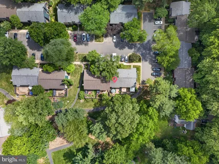 an aerial view of a house with a yard and lake view