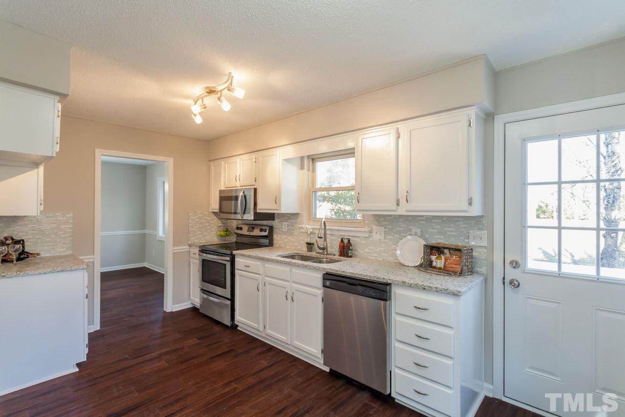 834 Horton Road Durham, NC 27704 - Photo 2 of 22 a kitchen with a sink cabinets and wooden floor