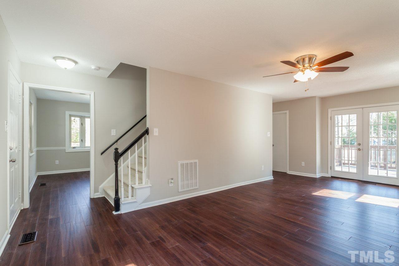 834 Horton Road Durham, NC 27704 - Photo 12 of 22 a view of an empty room with wooden floor and a ceiling fan