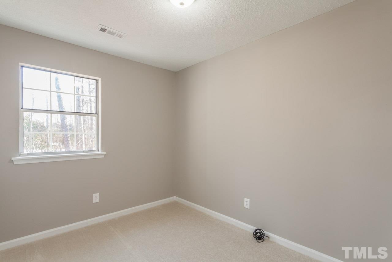 834 Horton Road Durham, NC 27704 - Photo 15 of 22 a view of an empty room with a window