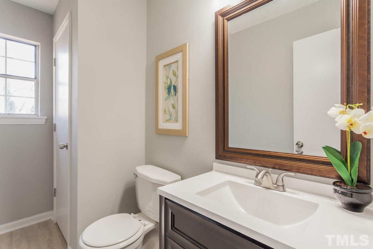 834 Horton Road Durham, NC 27704 - Photo 17 of 22 a bathroom with a sink toilet and mirror