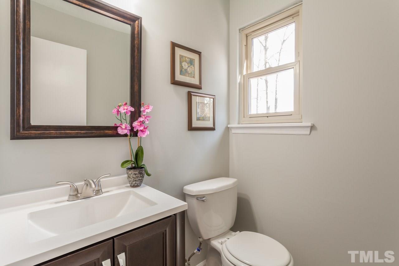 834 Horton Road Durham, NC 27704 - Photo 18 of 22 a bathroom with a sink mirror and toilet