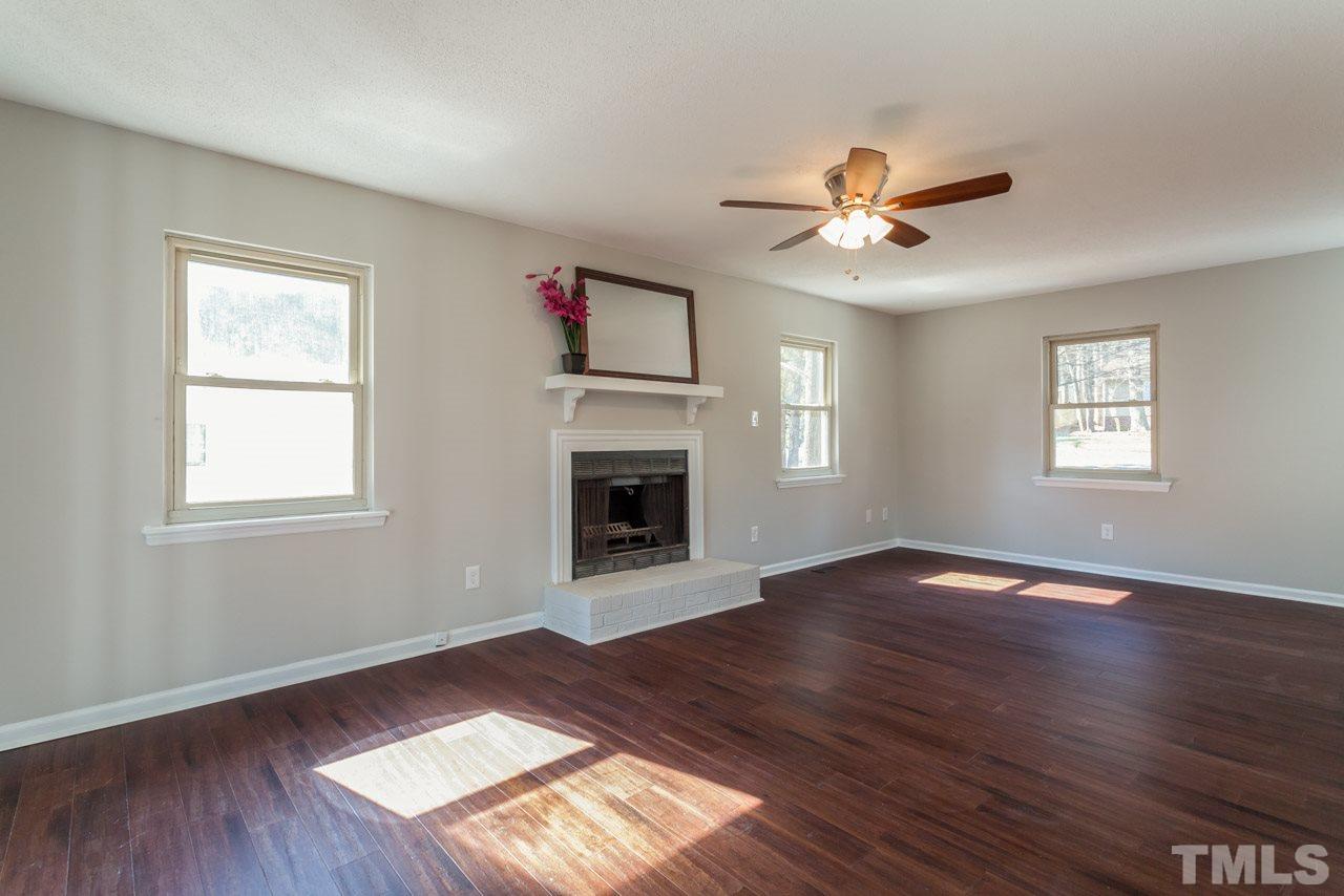 834 Horton Road Durham, NC 27704 - Photo 3 of 22 a view of an empty room with wooden floor and a window