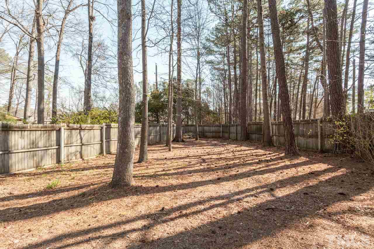 834 Horton Road Durham, NC 27704 - Photo 21 of 22 a view of backyard with wooden fence and large trees