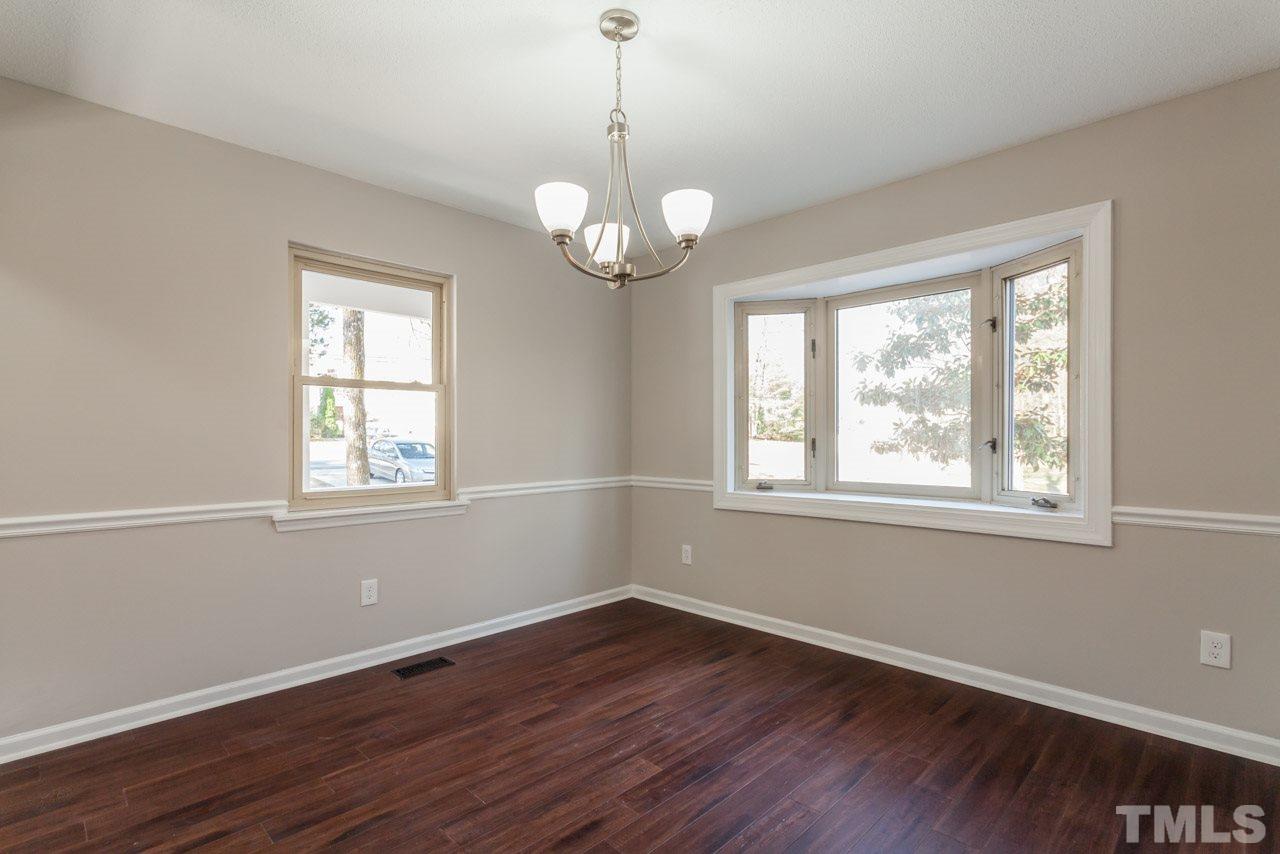 834 Horton Road Durham, NC 27704 - Photo 4 of 22 a view of an empty room with wooden floor and a window