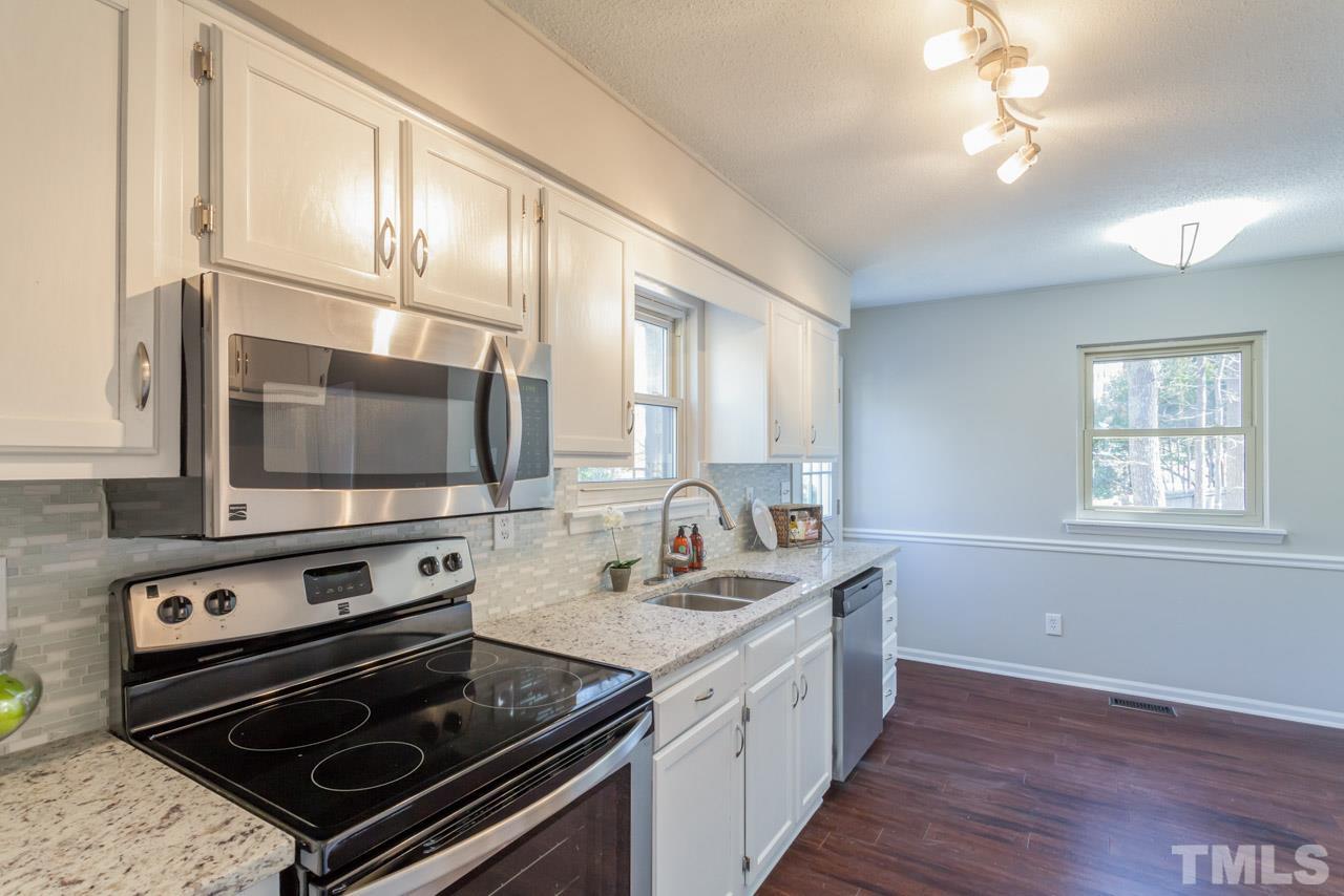 834 Horton Road Durham, NC 27704 - Photo 8 of 22 a kitchen with a stove a sink and a microwave