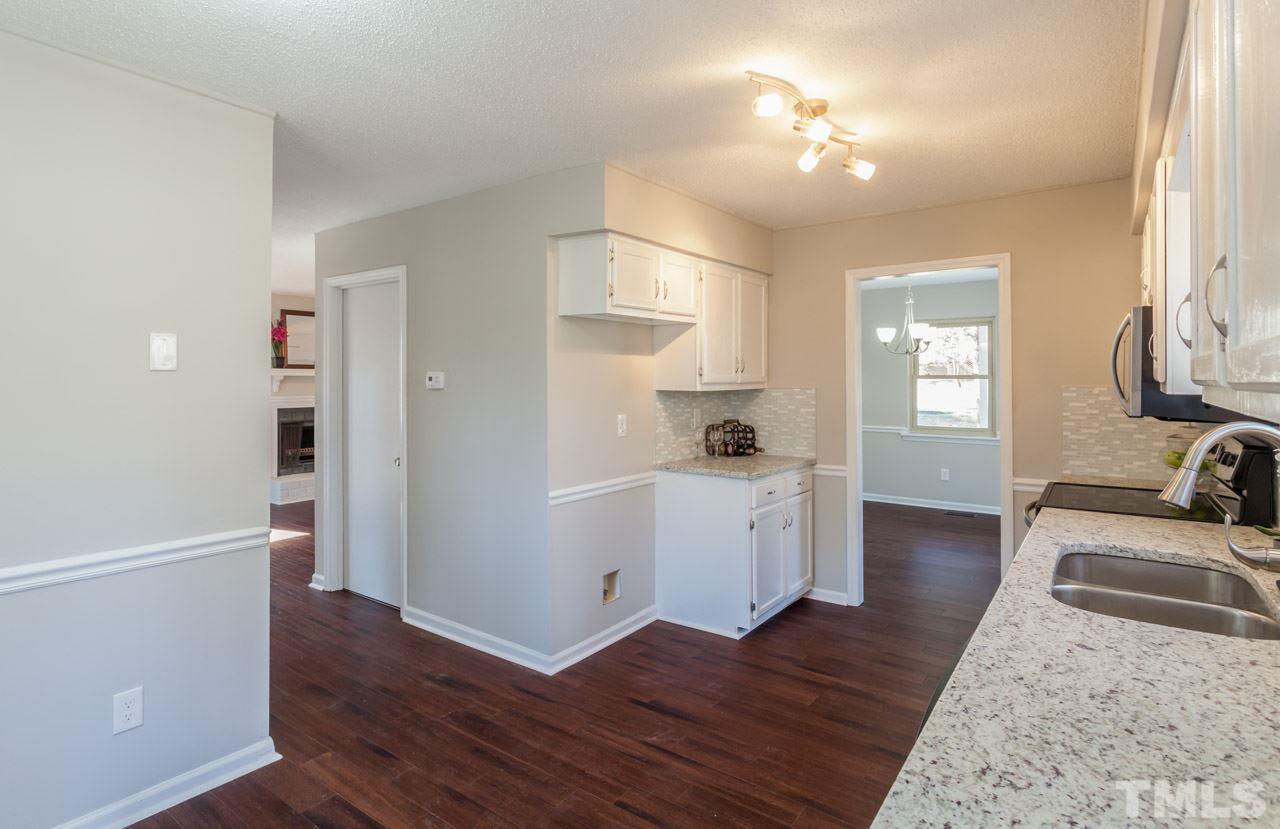 834 Horton Road Durham, NC 27704 - Photo 9 of 22 a view of a kitchen with wooden floor and a window