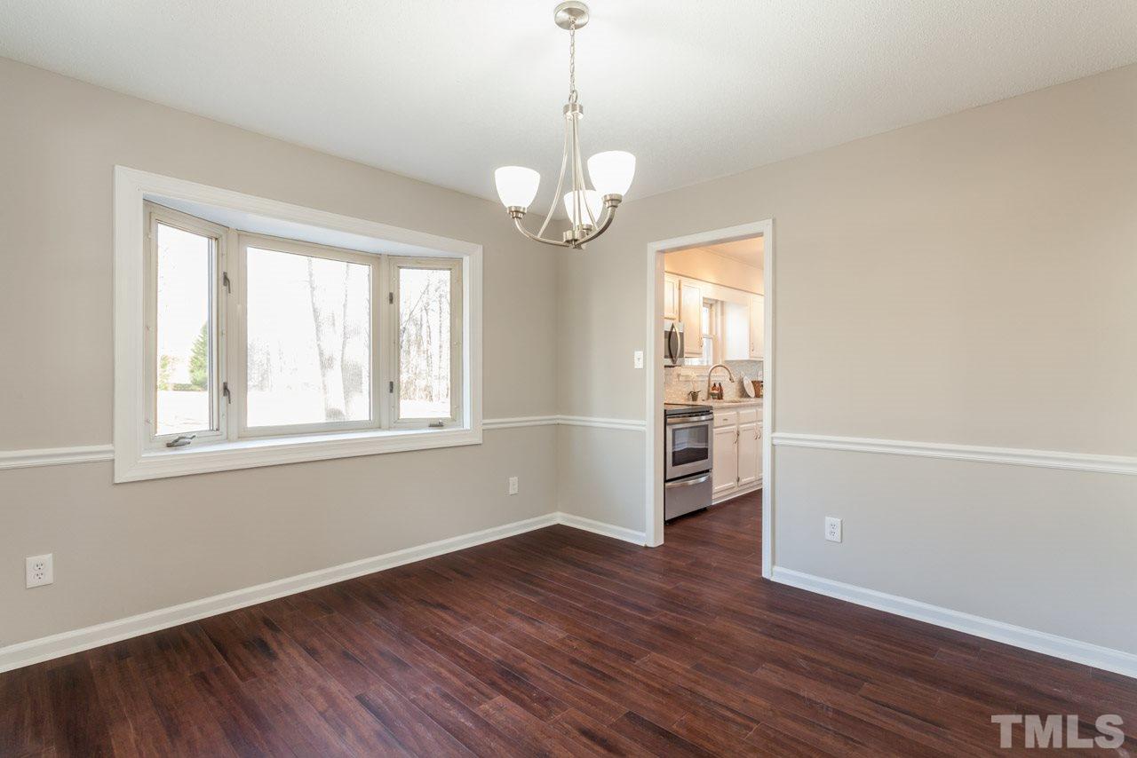 834 Horton Road Durham, NC 27704 - Photo 10 of 22 a view of an empty room with wooden floor and a window