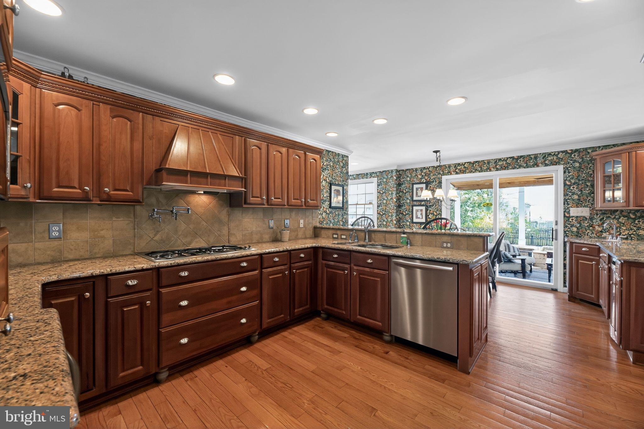 42 Callison Lane Voorhees, NJ 08043 - Photo 11 of 55 a kitchen with stainless steel appliances granite countertop wooden cabinets a stove a sink and a large window