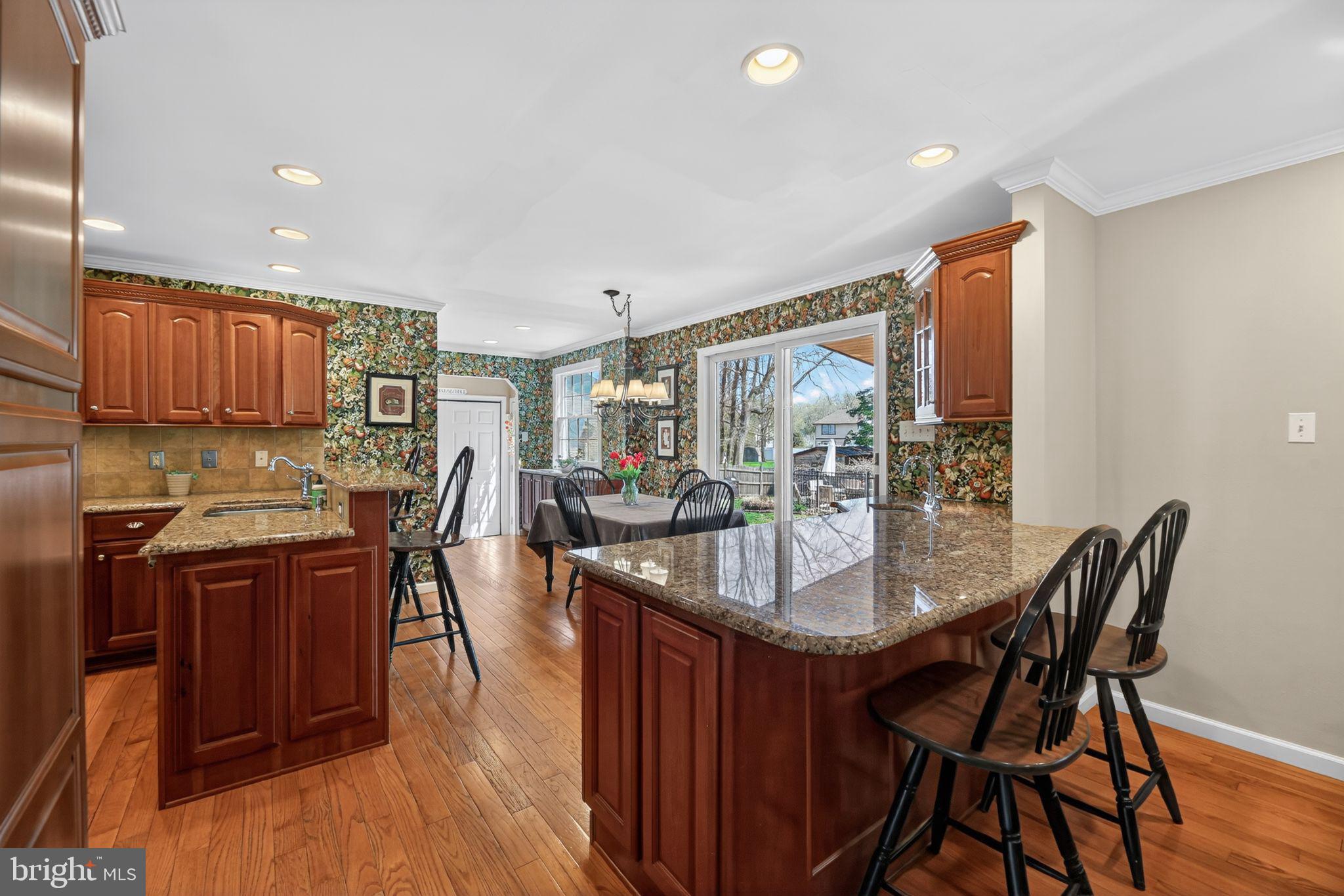 42 Callison Lane Voorhees, NJ 08043 - Photo 13 of 55 a kitchen with granite countertop sink dining table and chairs