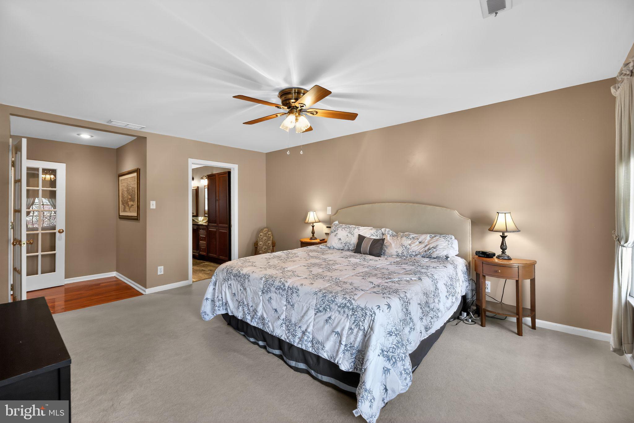 42 Callison Lane Voorhees, NJ 08043 - Photo 21 of 55 a bedroom with a bed and a chandelier