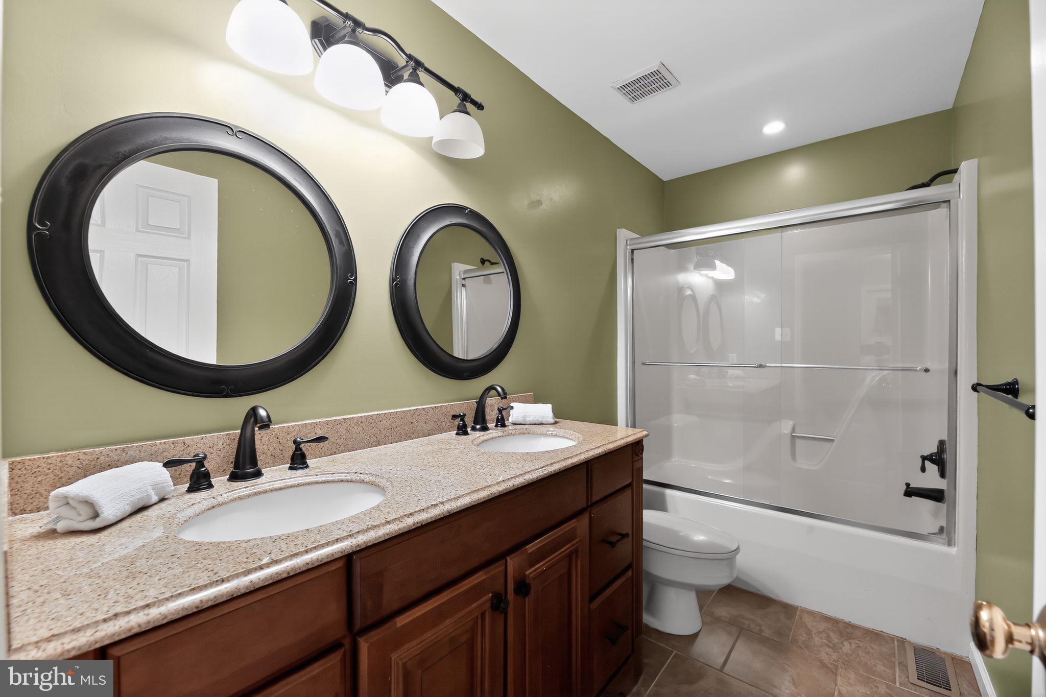 42 Callison Lane Voorhees, NJ 08043 - Photo 36 of 55 a bathroom with a granite countertop toilet a sink and a mirror