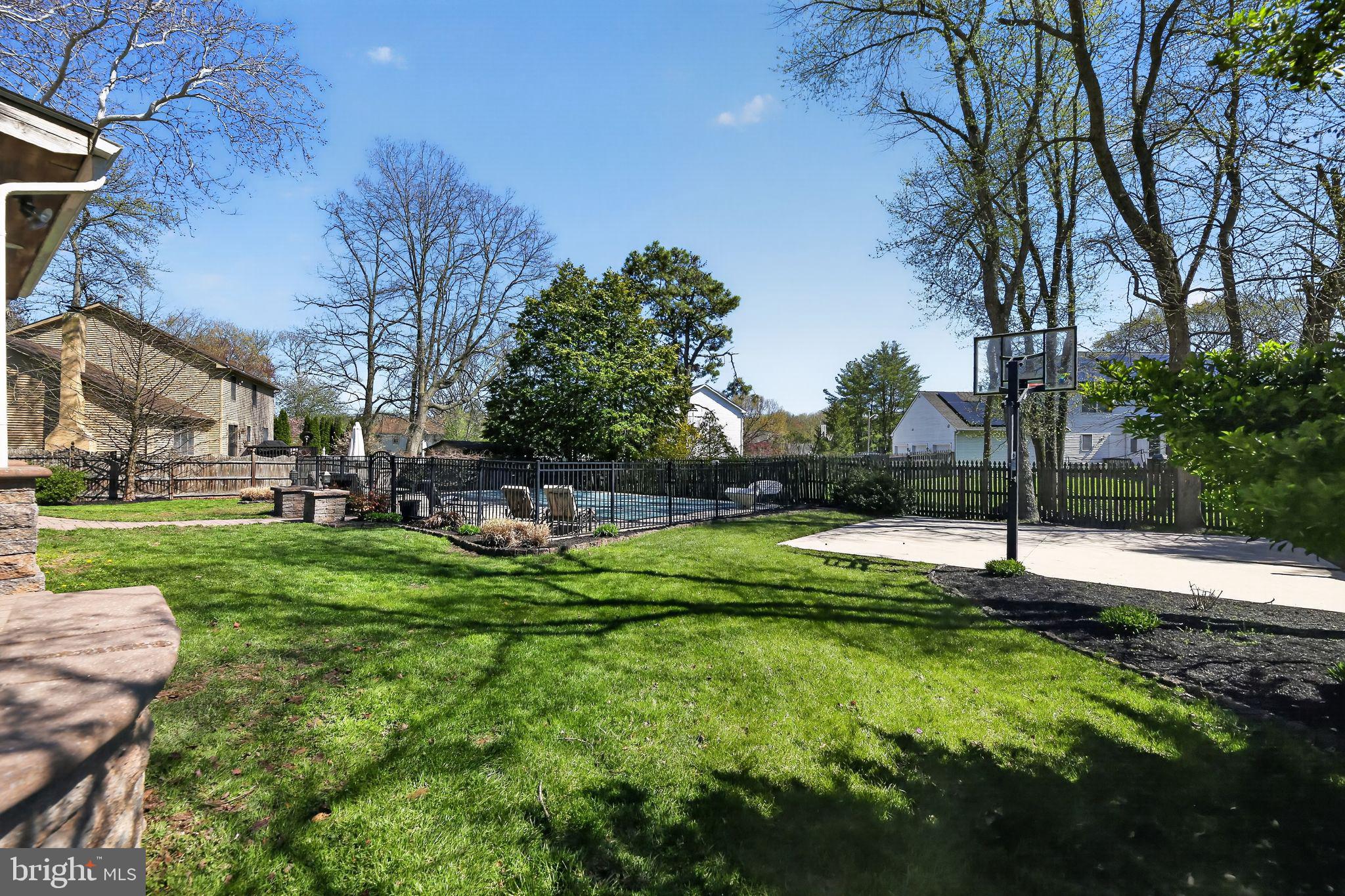 42 Callison Lane Voorhees, NJ 08043 - Photo 55 of 55 a swimming pool with lots of tress in front of it