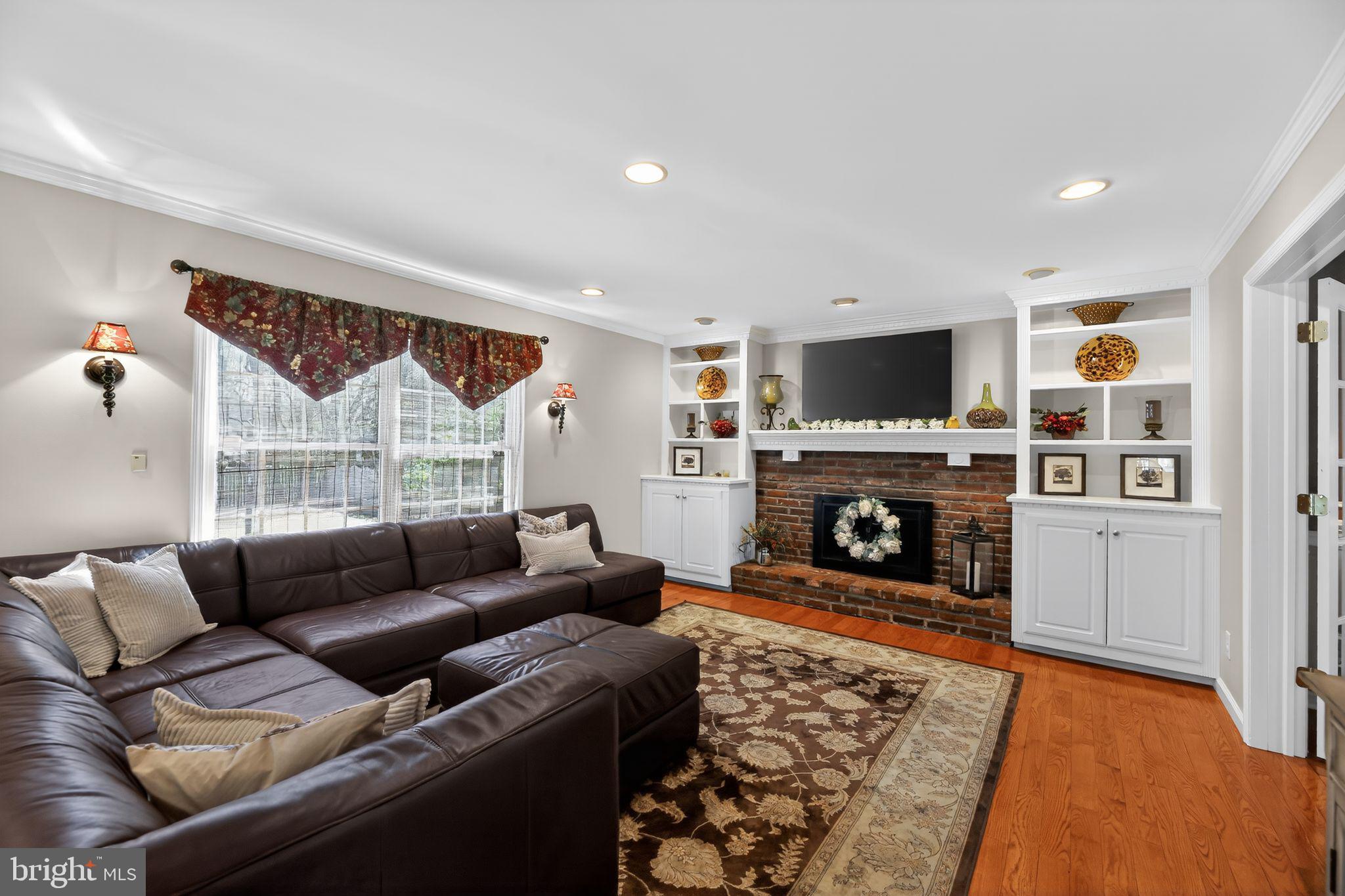 42 Callison Lane Voorhees, NJ 08043 - Photo 7 of 55 a living room with furniture a flat screen tv and a fireplace