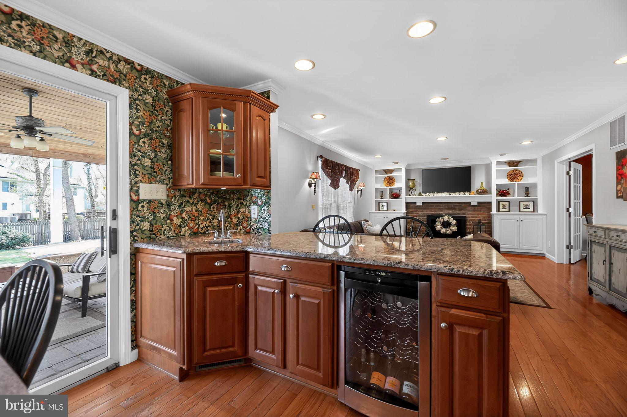 42 Callison Lane Voorhees, NJ 08043 - Photo 9 of 55 a kitchen with stainless steel appliances granite countertop wooden floors and wooden cabinets