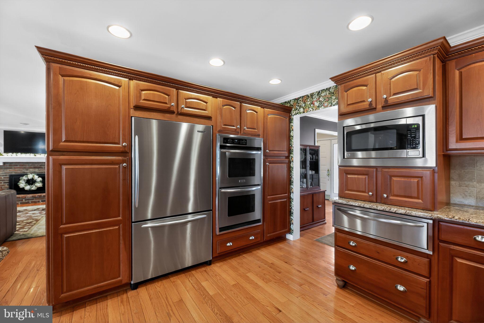 42 Callison Lane Voorhees, NJ 08043 - Photo 10 of 55 a kitchen with stainless steel appliances and wooden cabinets