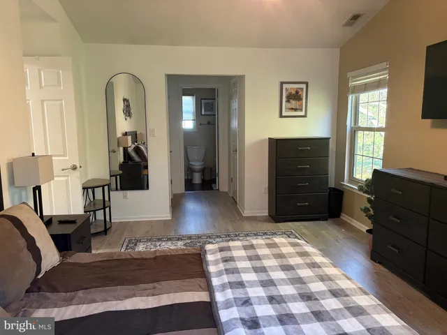 a living room with furniture and a dresser