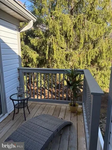 a view of a balcony with wooden chairs and floor