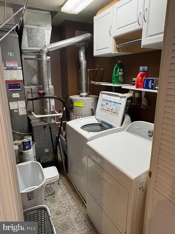 a utility room with dryer washer and shoe rack