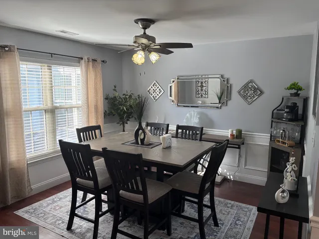 a view of a dining room with furniture and chandelier