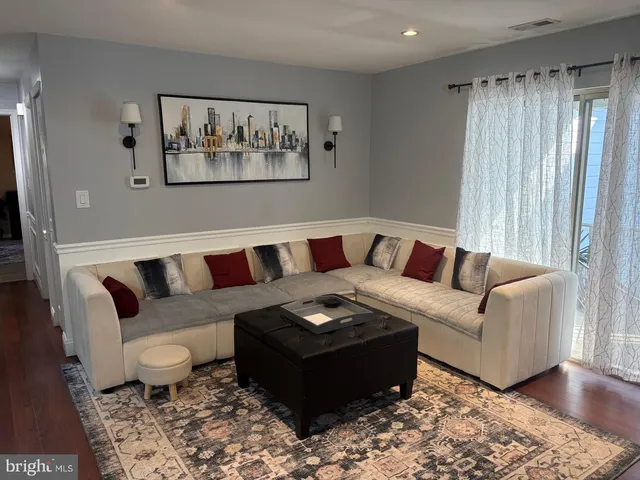 a living room with furniture and a rug