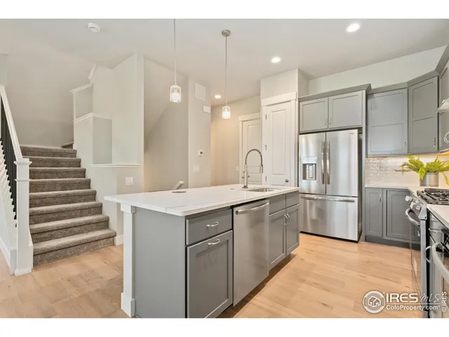 a kitchen with a sink stainless steel appliances and cabinets