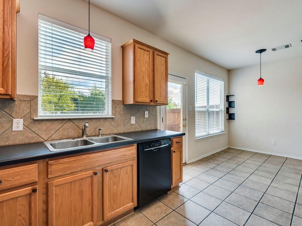 6 Verde Ranch Loop Leander, TX 78641 - Photo 11 of 24 a kitchen with stainless steel appliances granite countertop a sink and a window