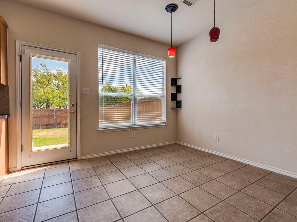 6 Verde Ranch Loop Leander, TX 78641 - Photo 12 of 24 Unfurnished dining area with light tile patterned flooring and baseboards