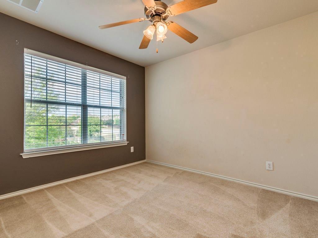 6 Verde Ranch Loop Leander, TX 78641 - Photo 17 of 24 Empty room with light carpet and a ceiling fan