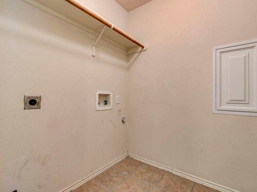 6 Verde Ranch Loop Leander, TX 78641 - Photo 21 of 24 Washroom with hookup for an electric dryer, hookup for a gas dryer, hookup for a washing machine, and light tile patterned floors