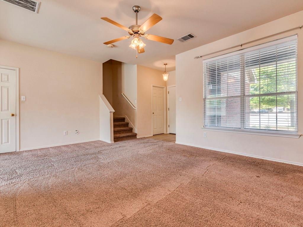 6 Verde Ranch Loop Leander, TX 78641 - Photo 7 of 24 Spare room featuring a ceiling fan, carpet flooring, and stairway