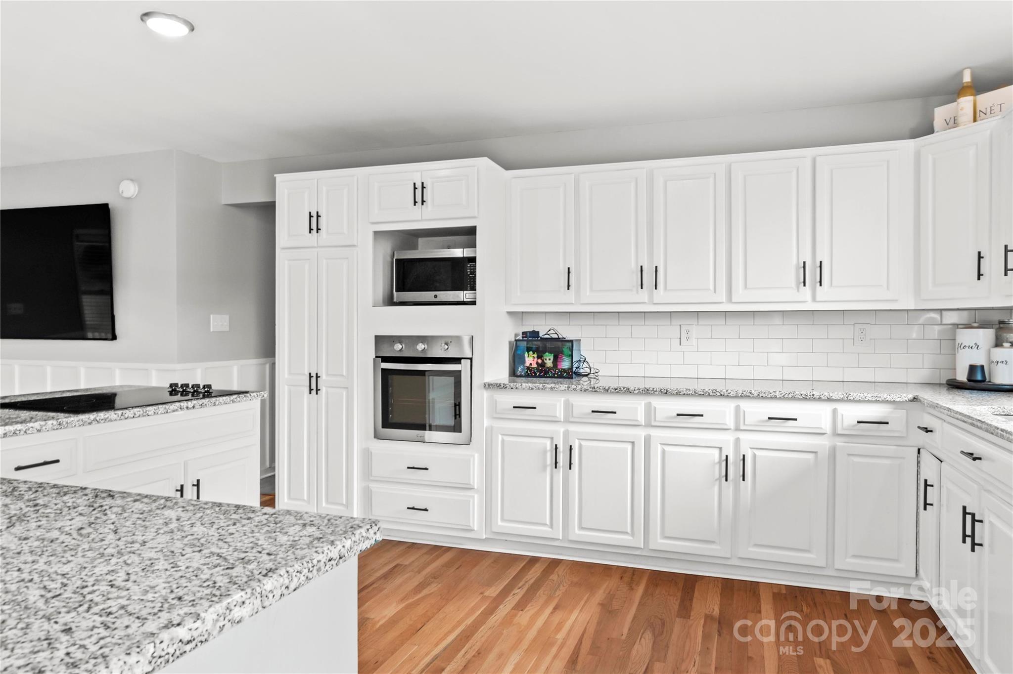 1627 Stony Knoll Road Dobson, NC 27017 - Photo 13 of 43 a kitchen with stainless steel appliances granite countertop a stove a sink and white cabinets