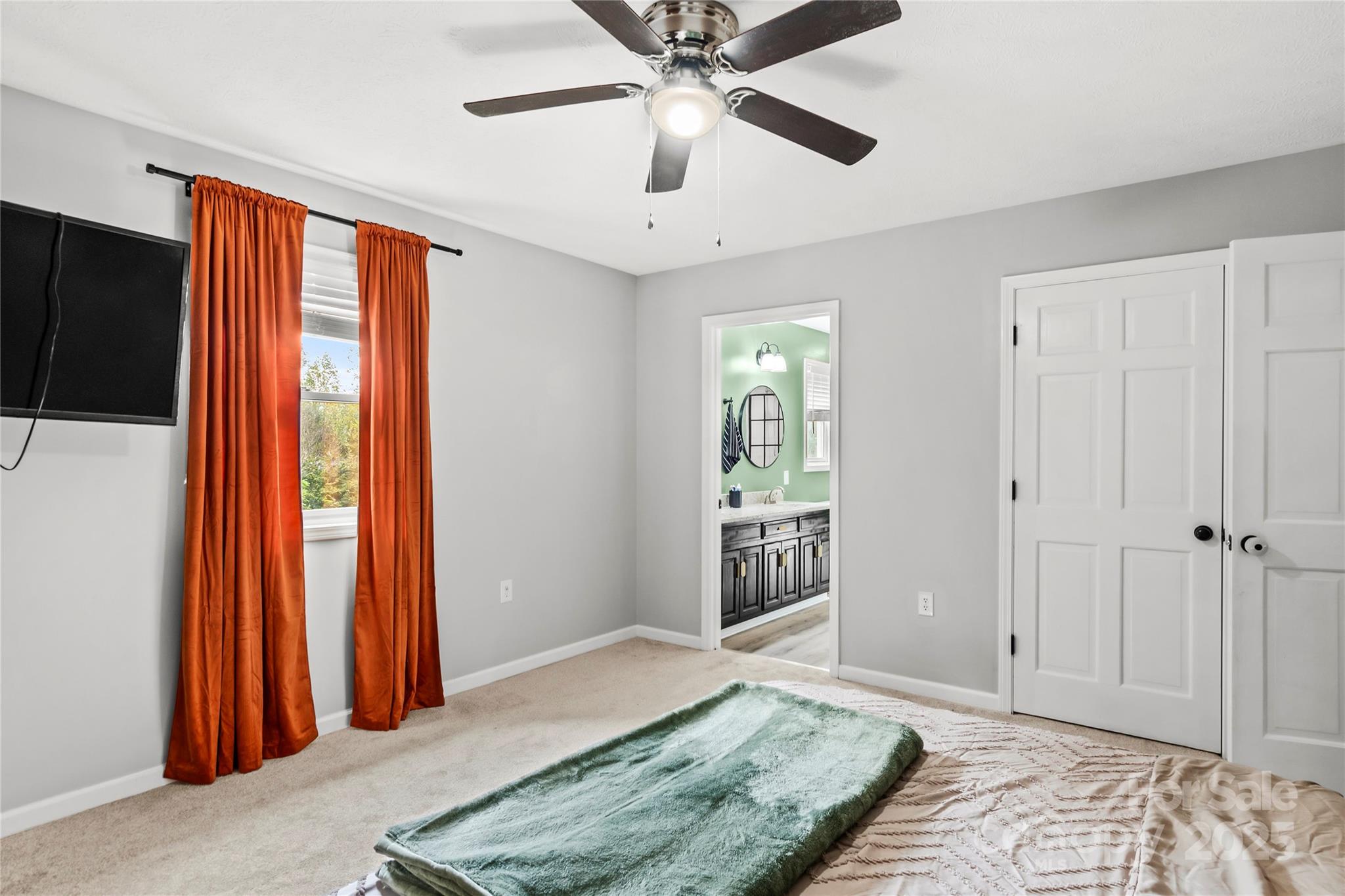 1627 Stony Knoll Road Dobson, NC 27017 - Photo 17 of 43 a bedroom with a bed and a chandelier