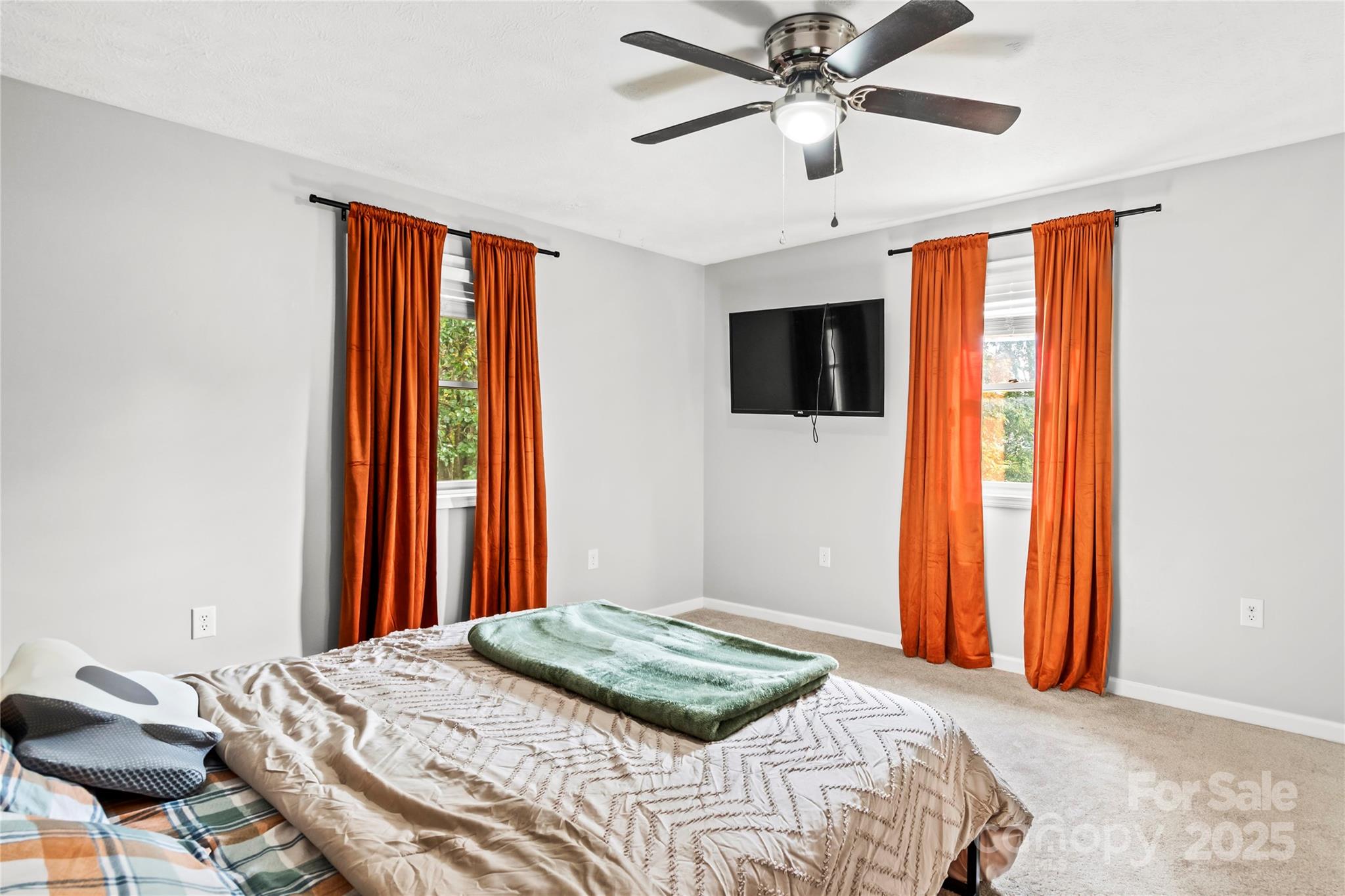 1627 Stony Knoll Road Dobson, NC 27017 - Photo 18 of 43 a bedroom with a bed and a flat screen tv