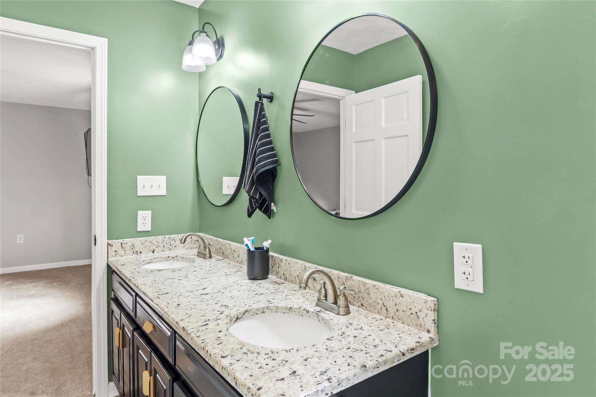 1627 Stony Knoll Road Dobson, NC 27017 - Photo 20 of 43 a bathroom with a granite countertop double vanity sink and a mirror